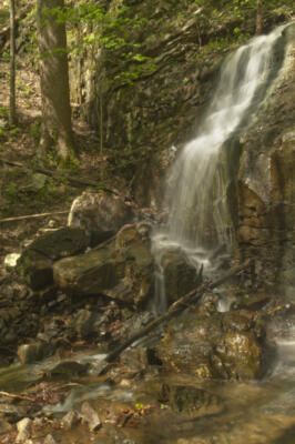 A falls on the side of the canyon above the trail