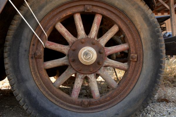 Wooden wheel on an old car.